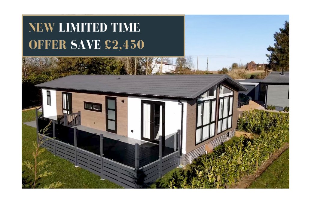 Promotional image showing a modern single-storey lodge with fenced decking and landscaped garden, overlaid with a banner reading ‘New limited time offer save £2,450’ in bold gold and white text.