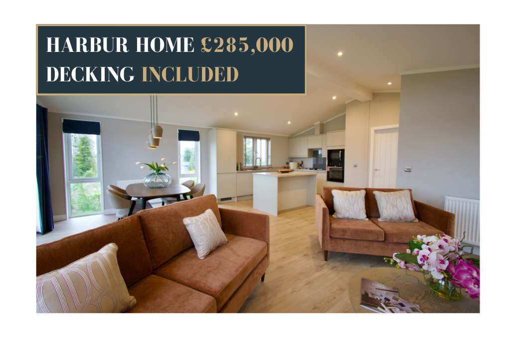 Interior view of the Harbur Home showing an open-plan living space with brown sofas, a dining table, and a modern fitted kitchen, overlaid with a banner reading ‘Harbur Home £285,000 decking included’ in gold and white text.